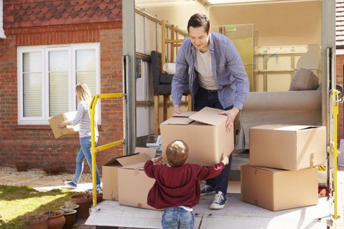 Removal team loading furniture into a moving van