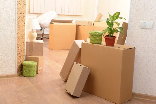 Professional movers navigating a Camden property with boxes